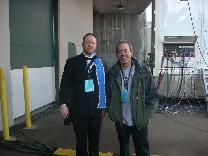 Sam Bowker in a tuxedo with a colleague outside a performance venue