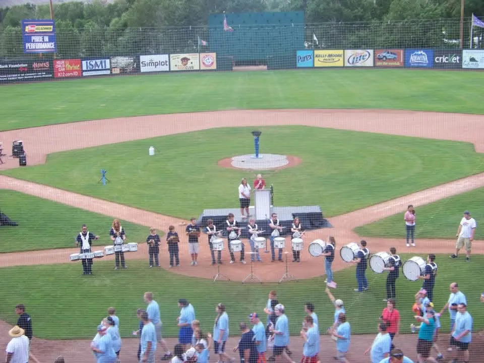 Drumline performing on a baseball field before a game